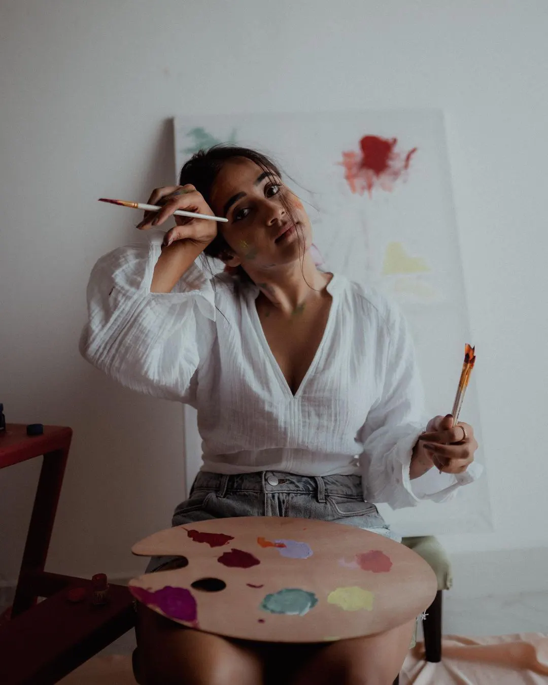 Deepti Sunaina posing for fun while painting