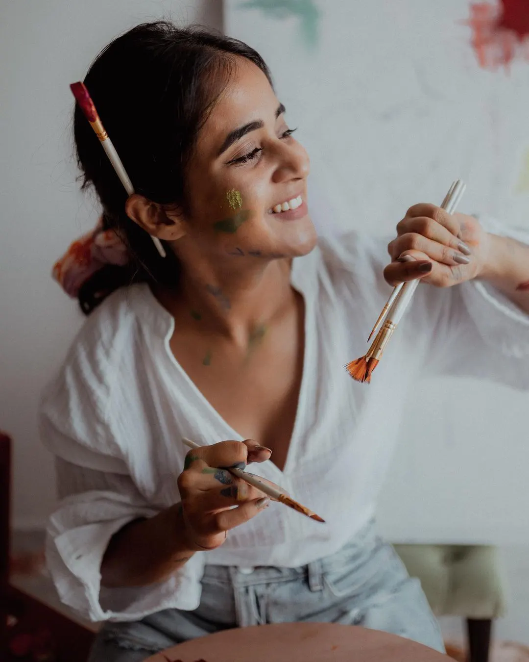 Deepti Sunaina posing for fun while painting