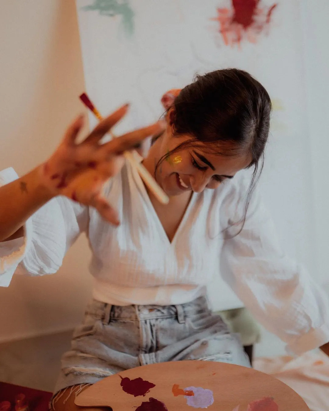 Deepti Sunaina posing for fun while painting