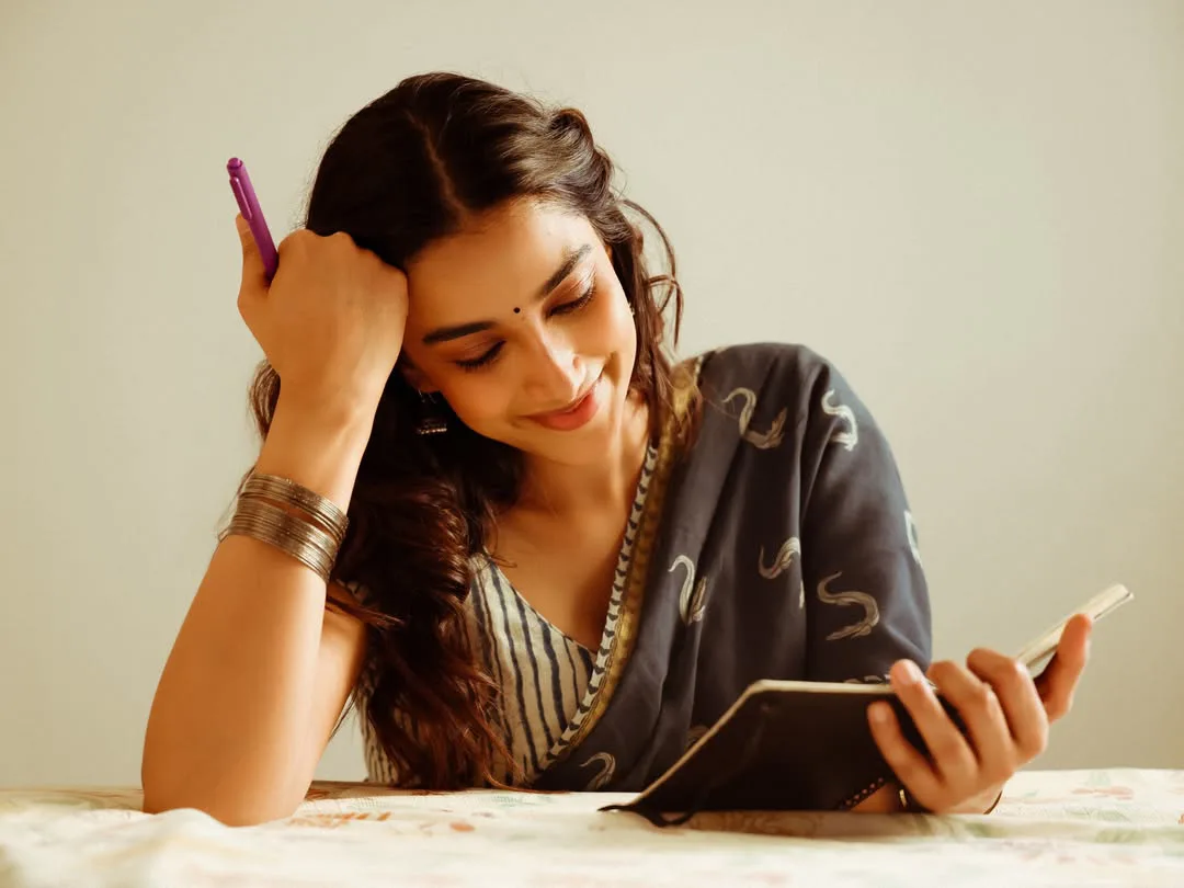Meenakshi Chaudhary strikes cute poses for photos with a book