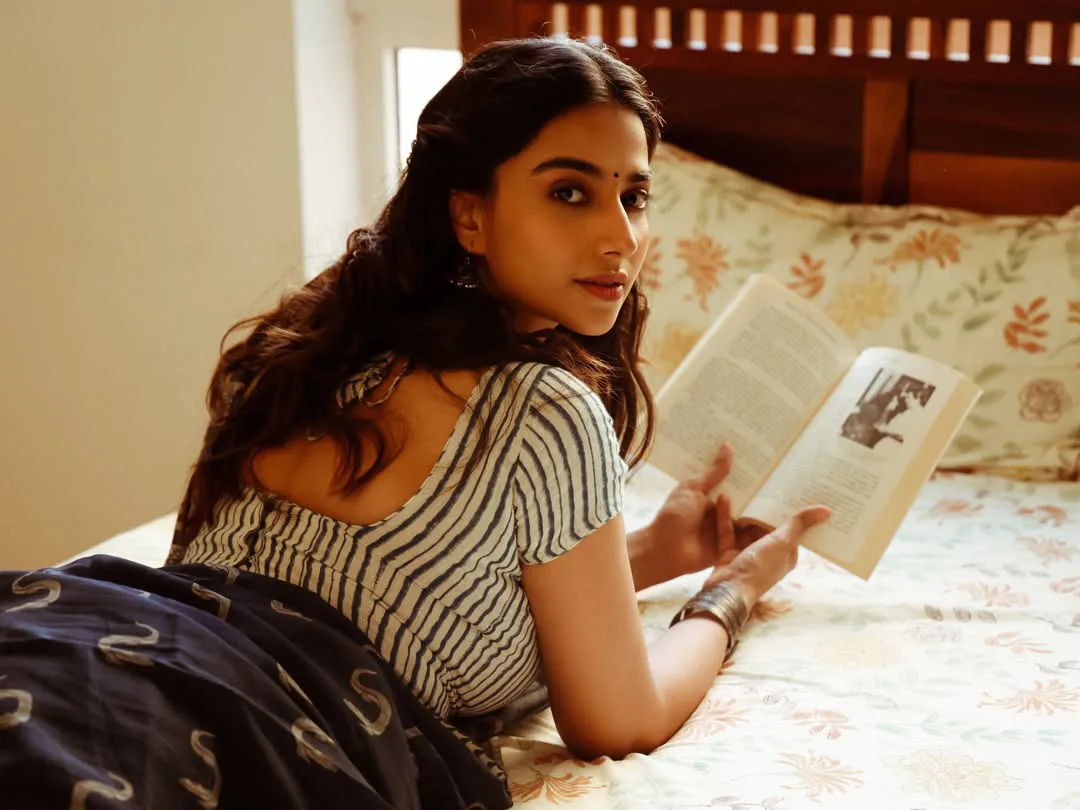Meenakshi Chaudhary strikes cute poses for photos with a book