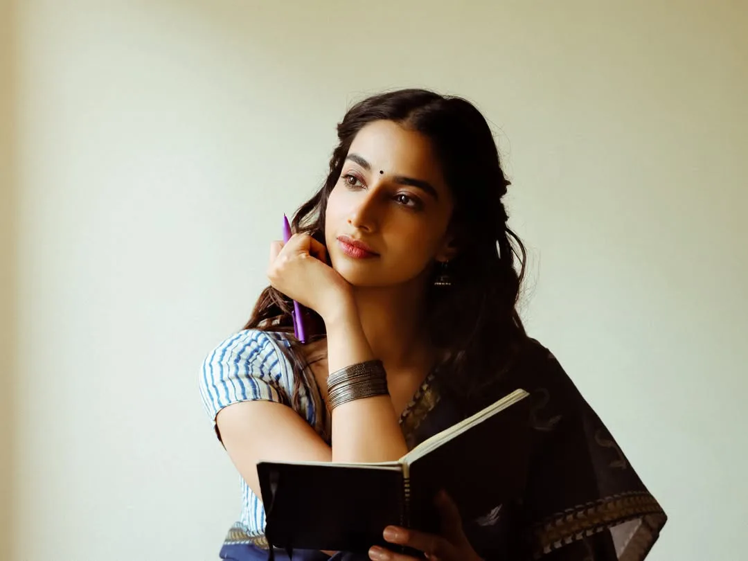 Meenakshi Chaudhary strikes cute poses for photos with a book