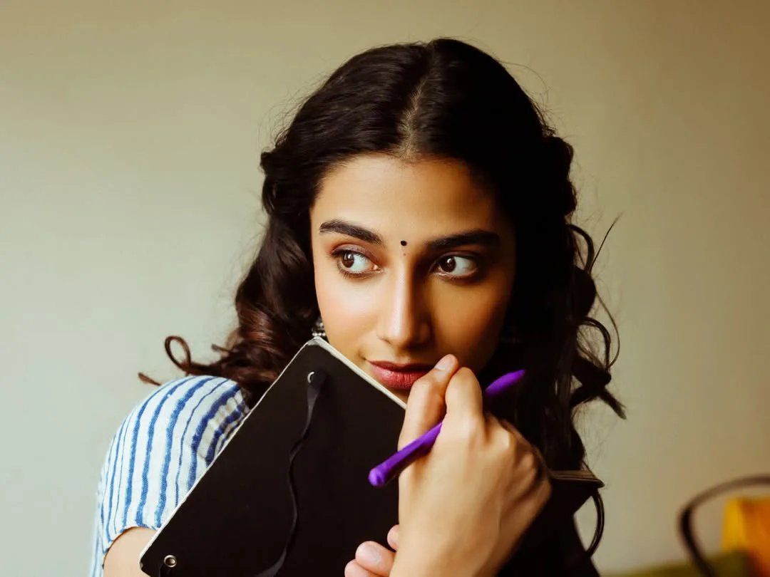 Meenakshi Chaudhary strikes cute poses for photos with a book