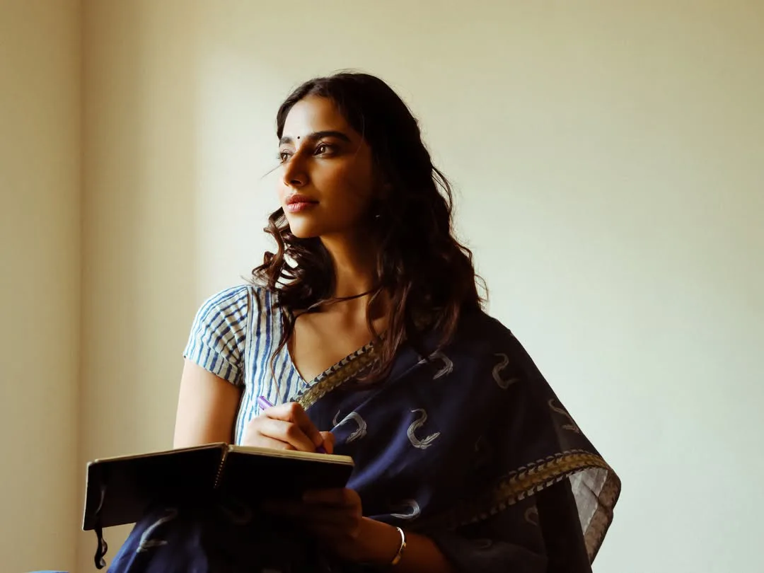 Meenakshi Chaudhary strikes cute poses for photos with a book
