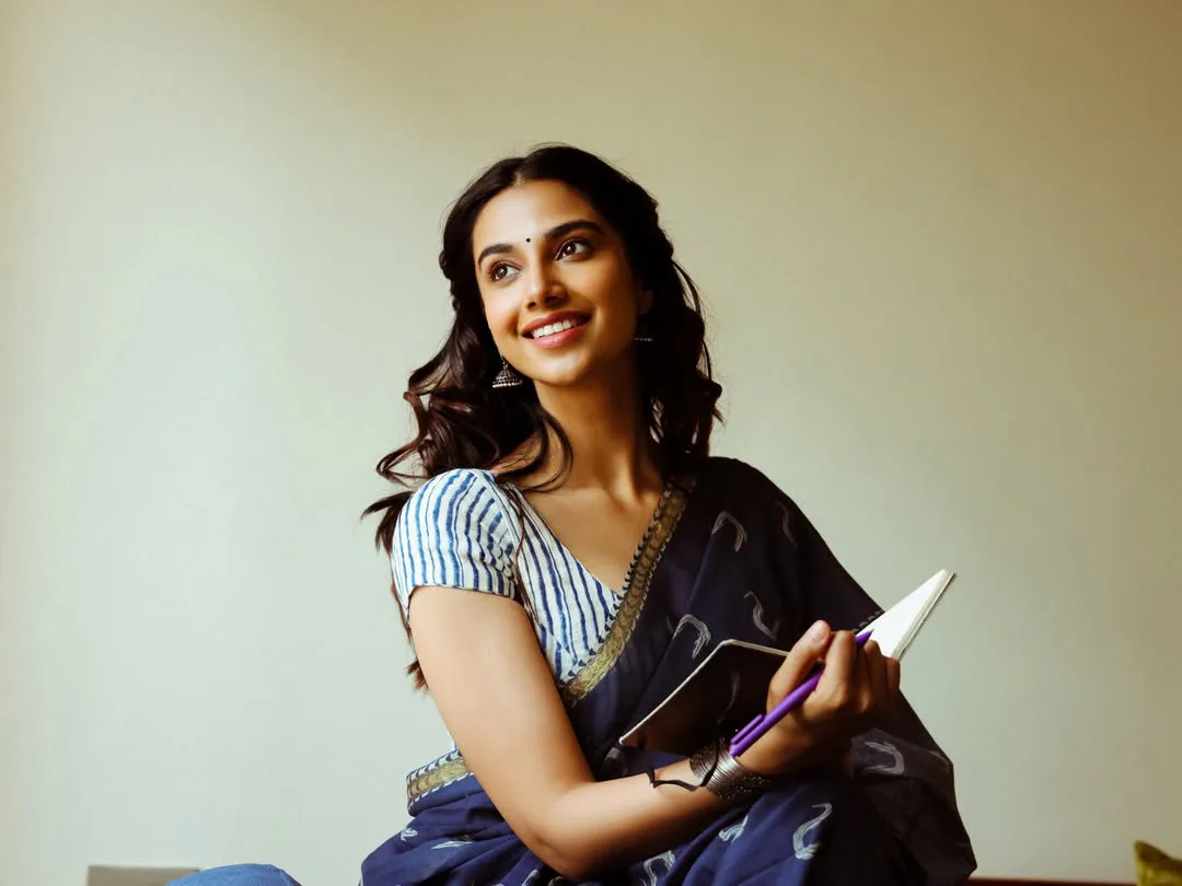 Meenakshi Chaudhary strikes cute poses for photos with a book