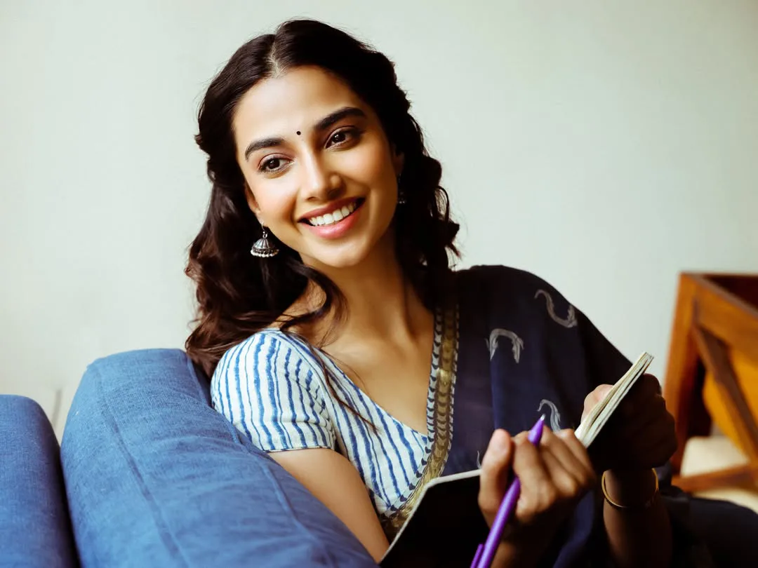Meenakshi Chaudhary strikes cute poses for photos with a book