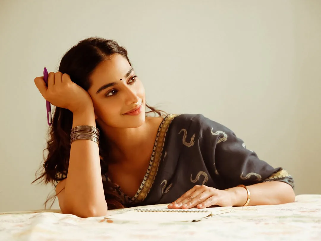 Meenakshi Chaudhary strikes cute poses for photos with a book
